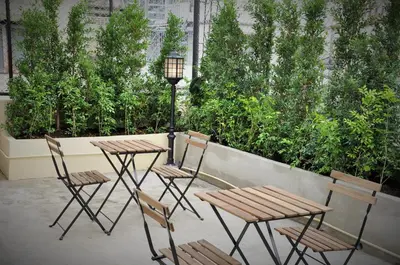 a group of tables and chairs on a patio at Cooper in Bangkok