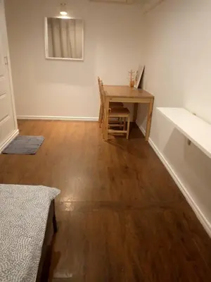 a room with a wooden table and a desk at Cooper in Bangkok