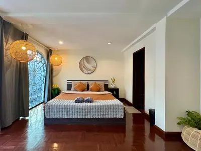 a bedroom with a bed and a large window at Private House 3 Suite Beds + Double Beds in Heart of Phromphong in Bangkok
