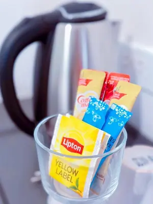 a glass bowl filled with chips and a tea kettle at 14 Sathorn Hotel in Bangkok
