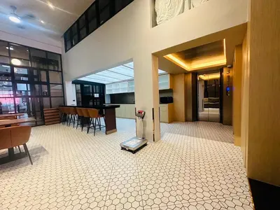 a living room with a table and chairs in a building at 14 Sathorn Hotel in Bangkok