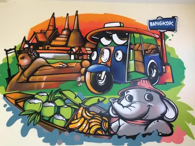 a mural of an elephant and a bus in front of a city at Aubon Hostel in Bangkok