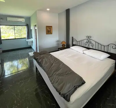 a bedroom with a large bed in a room at IMM Resort in Bangkok