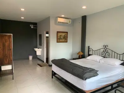 a bedroom with a large bed and a bathroom at IMM Resort in Bangkok