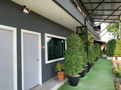 a row of potted plants on the side of a building at IMM Resort in Bangkok