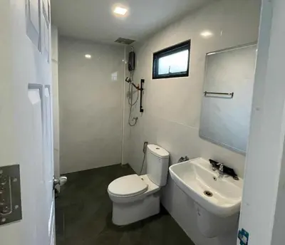 a white bathroom with a toilet and a sink at IMM Resort in Bangkok