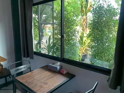 a window with a wooden table in front of it at IMM Resort in Bangkok