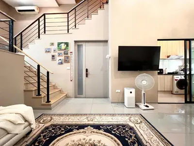 a living room with a staircase and a tv at Free pick up and Stunning Luxury Family Home 2B2B in Bangkok