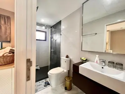 a bathroom with a toilet and a sink and a shower at Free pick up and Stunning Luxury Family Home 2B2B in Bangkok