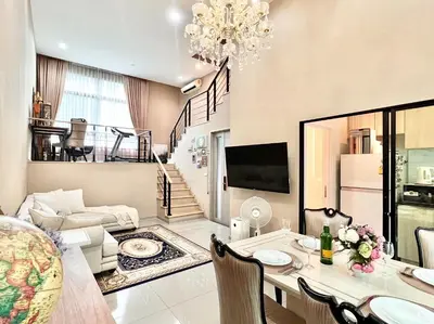 a living room with a table and a dining room at Free pick up and Stunning Luxury Family Home 2B2B in Bangkok