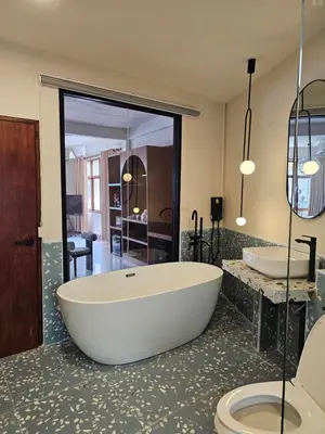 a large bathroom with a tub and a toilet at Yaowarat Stay in Bangkok