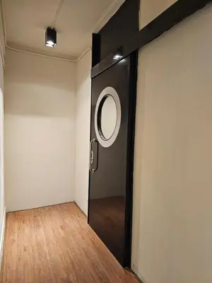 a room with a door with a mirror on it at Yaowarat Stay in Bangkok