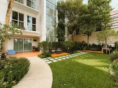 a garden in front of a building at Townhouse PK Garden in Bangkok