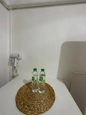two bottles of water sitting on top of a table at Thai Siwilai Hostel in Bangkok