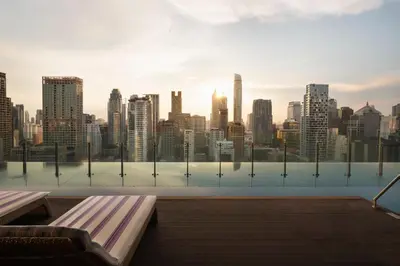 a pool with a view of a city skyline at Hotel Indigo Bangkok Wireless Road by IHG in Bangkok