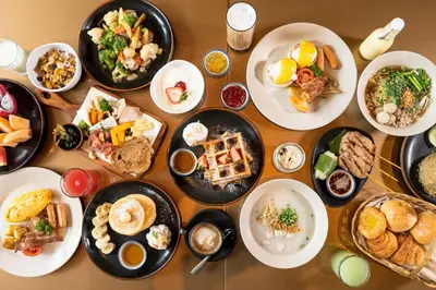 a table with many plates of food on it at Hotel Indigo Bangkok Wireless Road by IHG in Bangkok