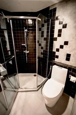 a bathroom with a toilet and a shower at C U Inn Bangkok in Bangkok