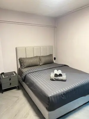 a bedroom with a bed with two shoes on it at Inntown in Amphoe Phra Khanong
