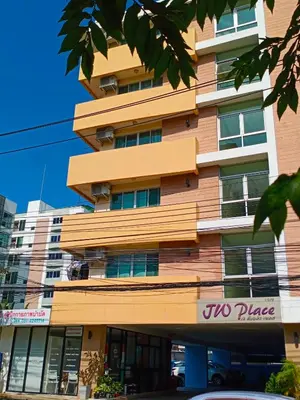 a tall building with a sign in front of it at jw place รามคำแหง 40 in Bangkok