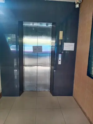 a metal elevator in a building with a sign on it at jw place รามคำแหง 40 in Bangkok