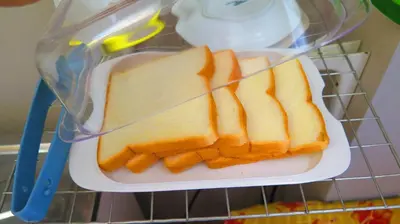 a plastic container with slices of bread on a plate at Fall Asleep hotel in Nonthaburi