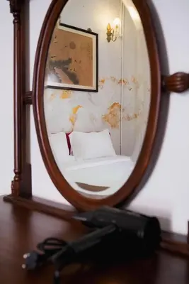 a mirror sitting on top of a wooden table at XX Mitr Inn Yaowarat - มิตร อินน์ เยาวราช in Khlong San
