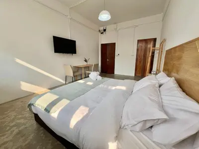 a large white bed in a room with a television at Sabay Home in Bangkok