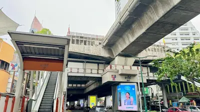 a bridge over a city street with a building at FRIENDS@SaiLom in Bangkok