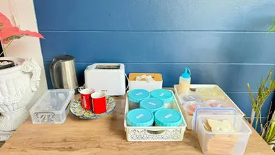 a table with containers of food and a toaster at FRIENDS@SaiLom in Bangkok