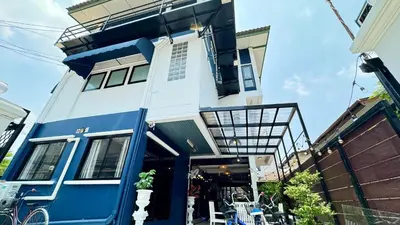 a blue and white house with a balcony at FRIENDS@SaiLom in Bangkok