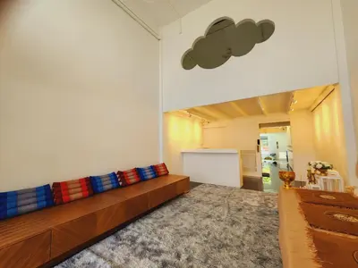 a living room with a couch with colorful pillows at Line Bangkok Hostel in Bangkok