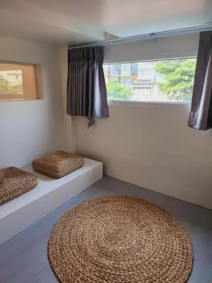 a room with two beds and a large window at Line Bangkok Hostel in Bangkok