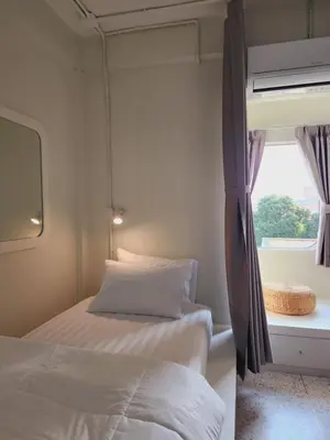 a bedroom with a bed and a window at Line Bangkok Hostel in Bangkok