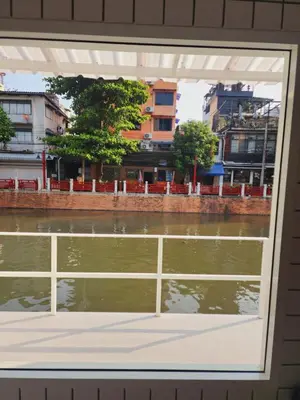 a window with a view of a body of water at Line Bangkok Hostel in Bangkok