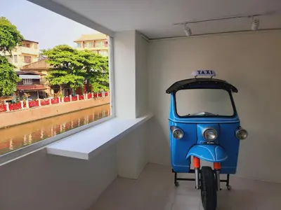a small blue motorcycle parked next to a window at Line Bangkok Hostel in Bangkok