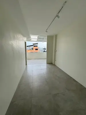 an empty room with white walls and a tile floor at Line Bangkok Hostel in Bangkok