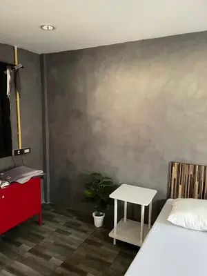a bedroom with a bed and a table with a plant at Brio Cafe and Hostel in Godown