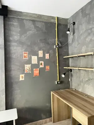 a room with a black wall with pictures on it at Brio Cafe and Hostel in Godown