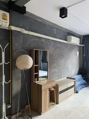 a bedroom with a desk and a mirror on a wall at Brio Cafe and Hostel in Godown