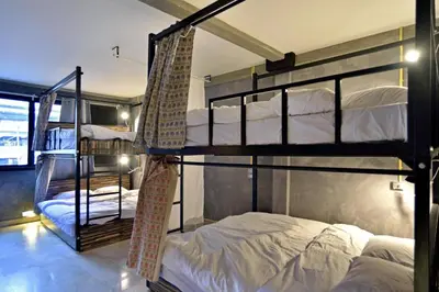a bedroom with two bunk beds and a window at Brio Cafe and Hostel in Godown
