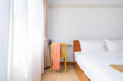 a bedroom with a bed and a yellow chair at Chummy House Khaosan 10-Min, Peace Haven in Bangkok