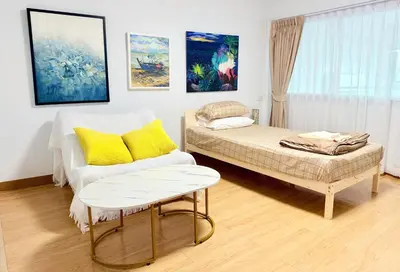 a living room with a couch and a table at Chummy House Khaosan 10-Min, Peace Haven in Bangkok