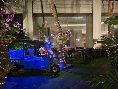 a blue scooter parked in front of a building at Sathorn prime Panorama City View rooftop bar in Bangkok