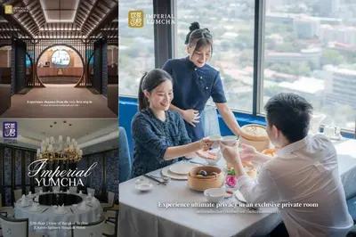 a woman and a man sitting at a table in a restaurant at Sathorn prime Panorama City View rooftop bar in Bangkok