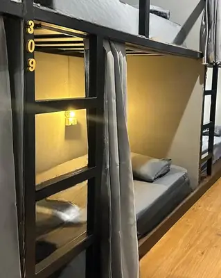 a bunk bed in a room with two beds at Bed Space Hostel Khaosan in Bangkok