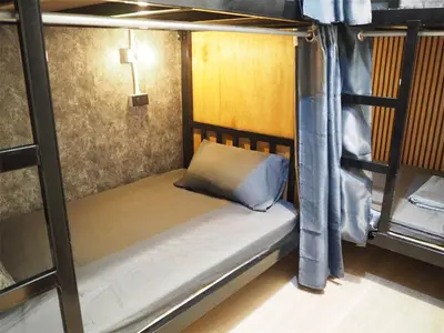 a bunk bed in a room with a cross on it at Bed Space Hostel Khaosan in Bangkok