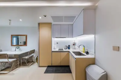 a kitchen with a sink and a table with chairs at Iconic skyline, Big apartment, Great location in Bangkok