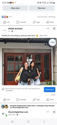 two women standing in front of a window at House Ju in Bangkok