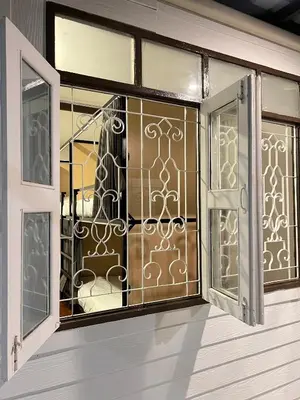 an open window with a wrought iron gate at House Ju in Bangkok