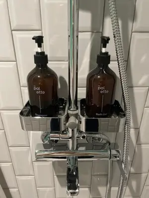 two bottles of soap in a bathroom sink at The Palette Bangkok Hotel - Self check-in after 10 pm in Bangkok